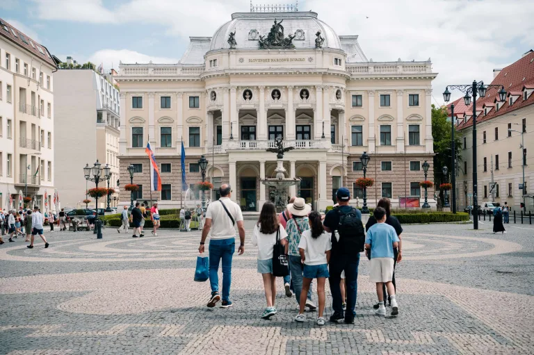 the clients discovering with the guide Bratislava, admiring Bratislava Old Teathre during active school group tour to Slovakia