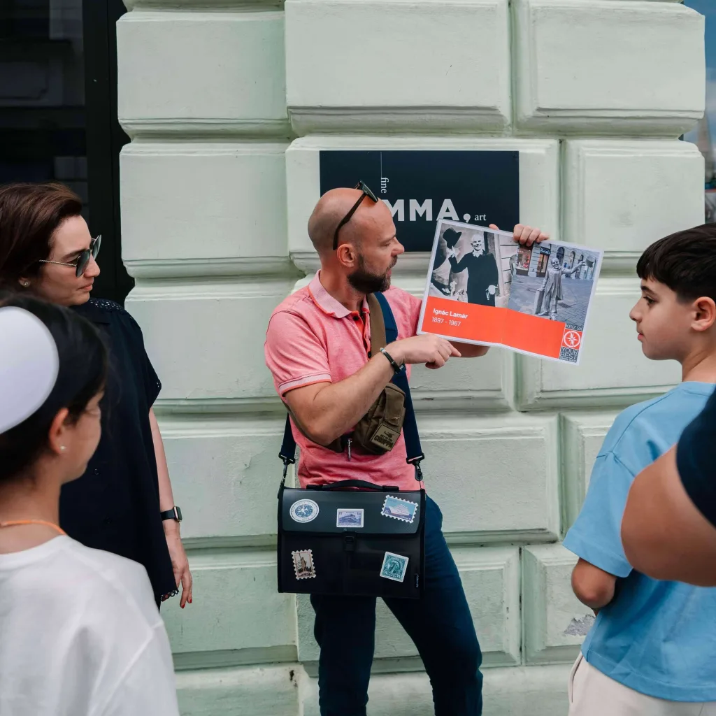 A guide showing to the clients booklet during Bratislava Grand City Tour