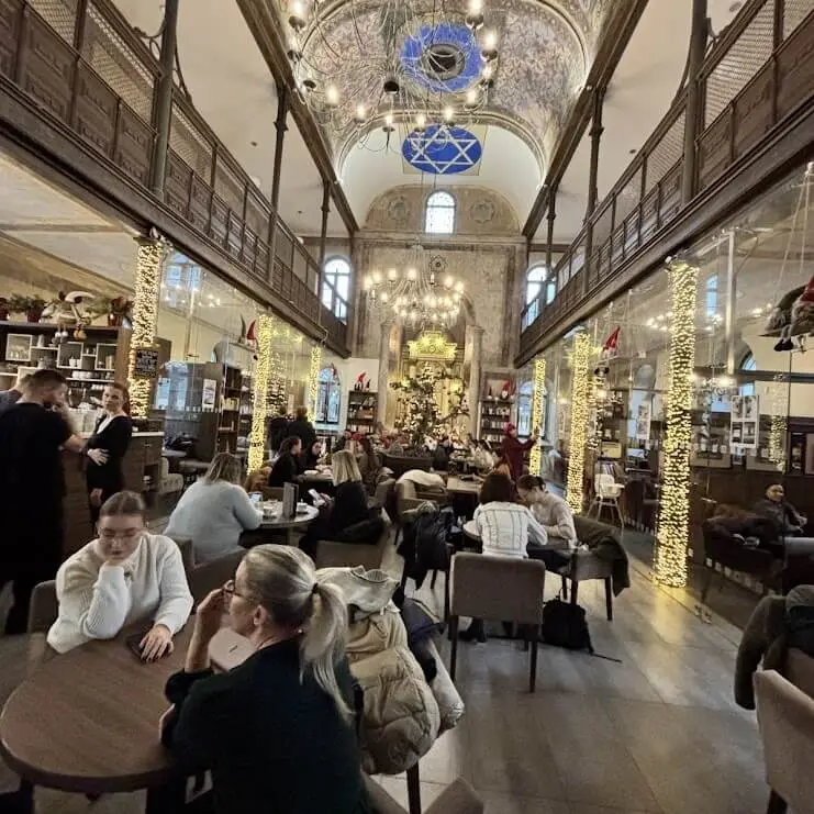Interior of Synagogue Café Trnava in converted 1891 Orthodox synagogue with guests, Slovakia