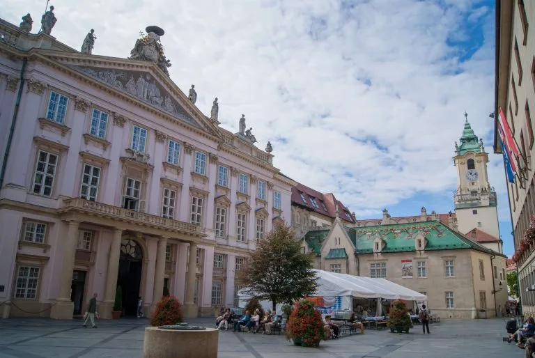 The pink Primate’s Palace on Primaciálne námestie in Bratislava, with the tower of the Old Town Hall rising beside it.