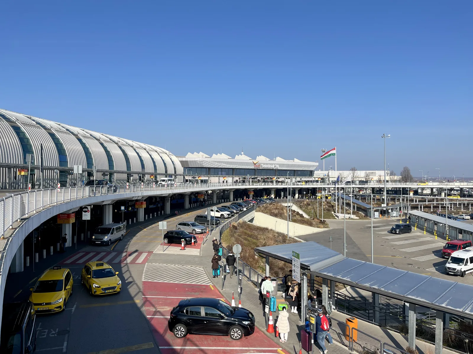 The terminal at Budapest Ferenc Liszt International Airport, with the curved roof of the arrivals and departures building.