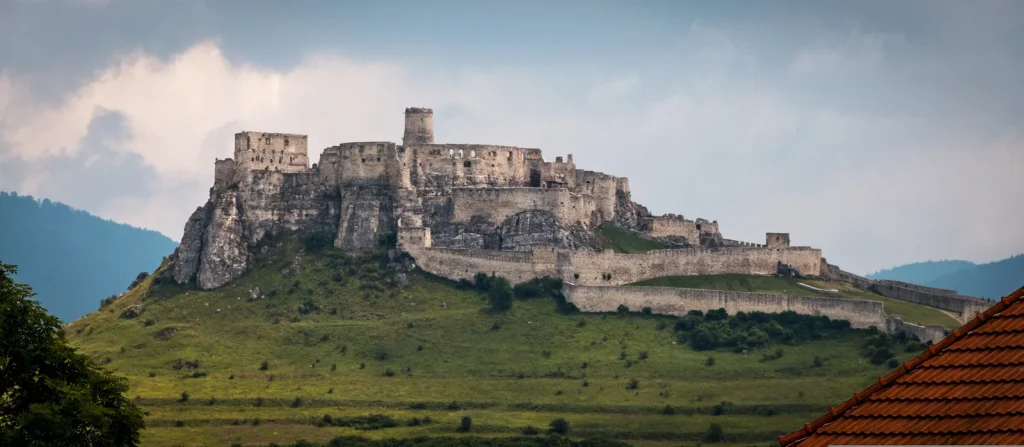 Spiš Castle on its limestone ridge above the Spiš plain, one of the largest castle complexes in Central Europe.