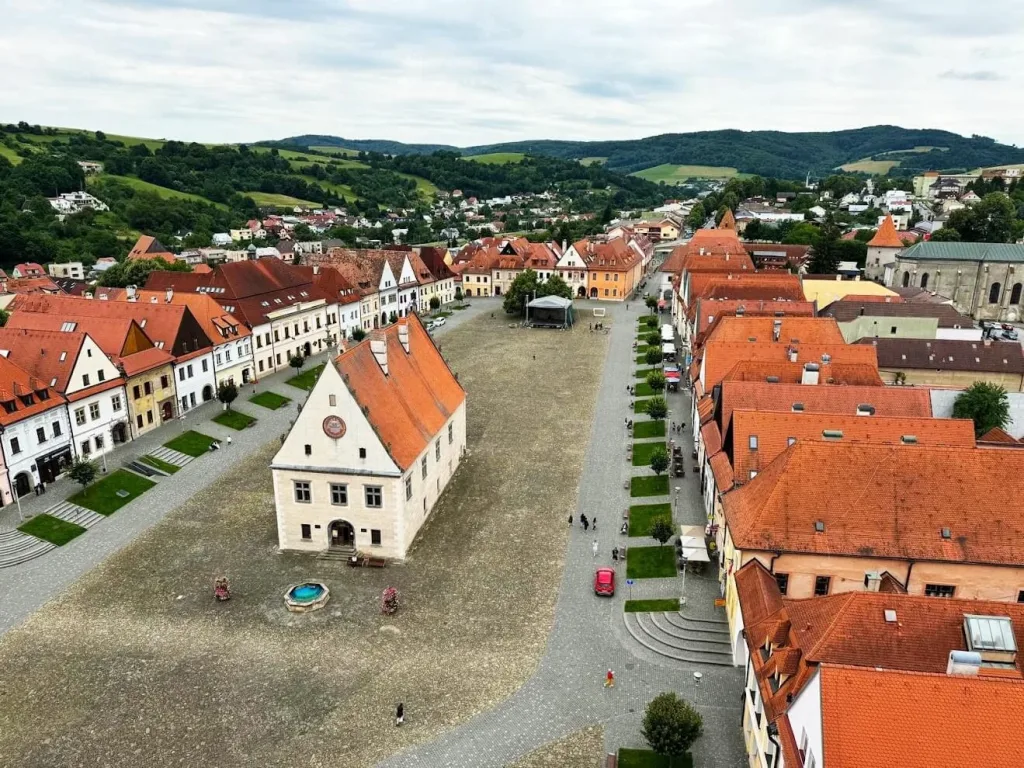 The UNESCO-listed main square of Bardejov from above, the old town hall standing alone on the cobbles between rows of gabled burgher houses.