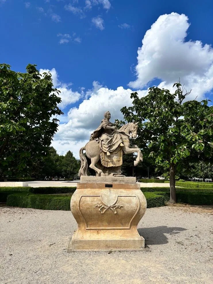 The equestrian statue of Maria Theresa on its stone pedestal in a Bratislava park.