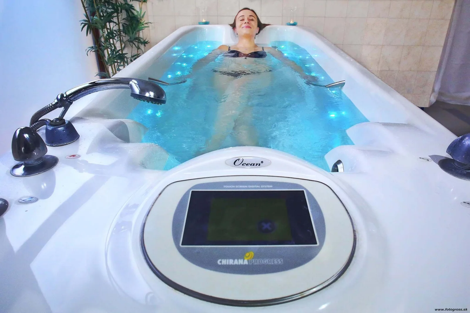 A guest relaxing in a hydromassage bath lit with blue lights at the Bojnice spa. Photo: www.fotogross.sk.