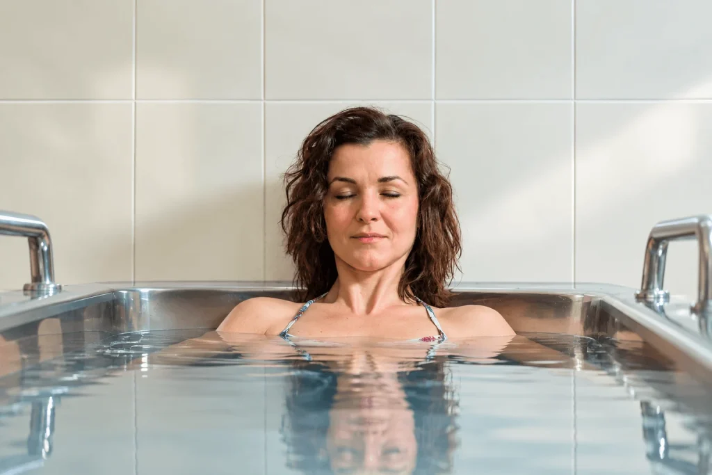 A mosaic-tiled steam room with a curved bench at the spa in Dudince.