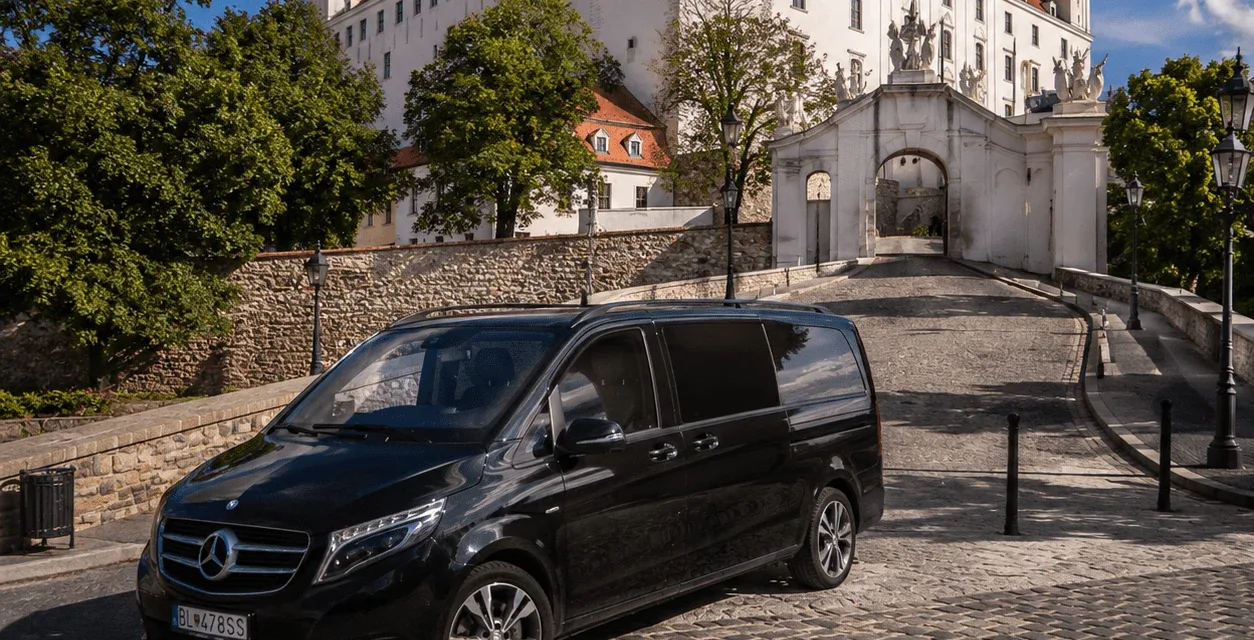 Чёрный Mercedes-Benz V-Class на мощёном подъезде к Братиславскому граду, ниже ворот замка.