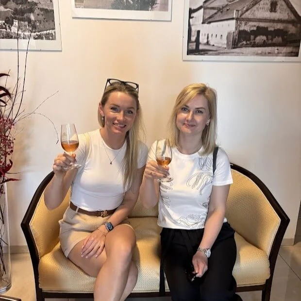 Two women raising glasses of honey wine during a mead tasting at Medolandia in Dolná Krupá.