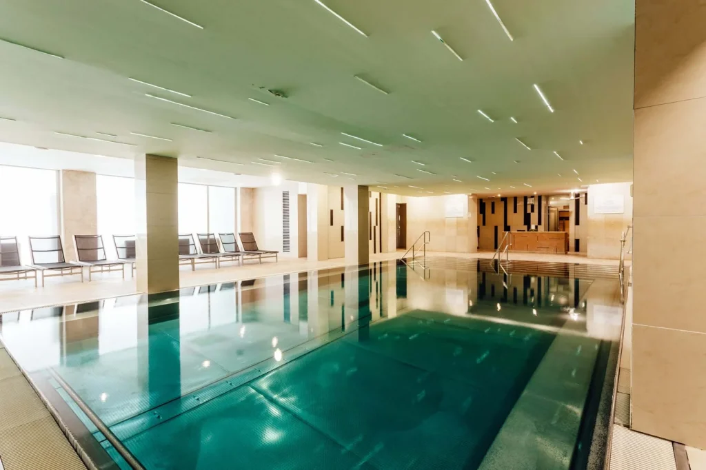 The indoor thermal pool at a spa hotel in Turčianske Teplice, with loungers along the windows.