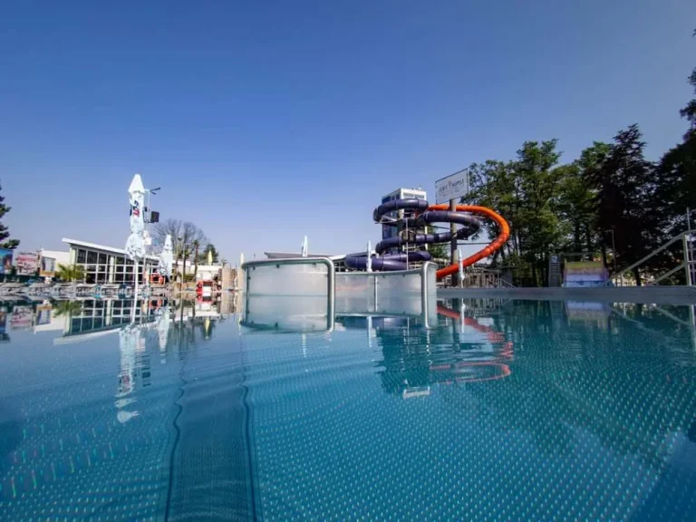 The outdoor pool and water slides in Turčianske Teplice on a clear summer day.
