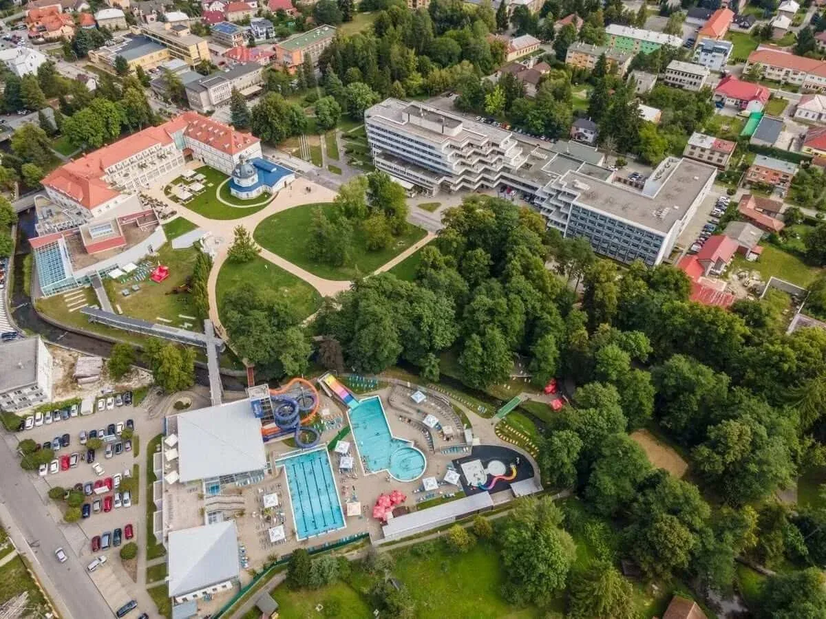 An aerial view of the spa quarter in Turčianske Teplice: spa hotels around the park, the historic Blue Bath and the outdoor pools with water slides.