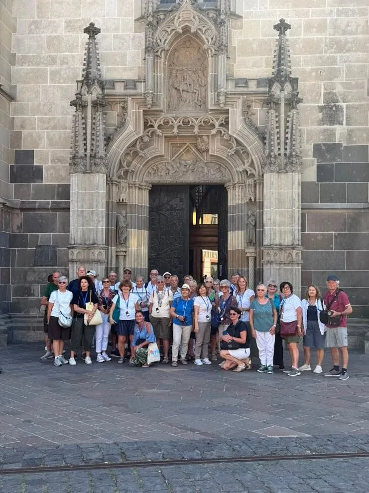 A tour group photographed in front of the carved Gothic portal of St Elisabeth Cathedral in Košice.