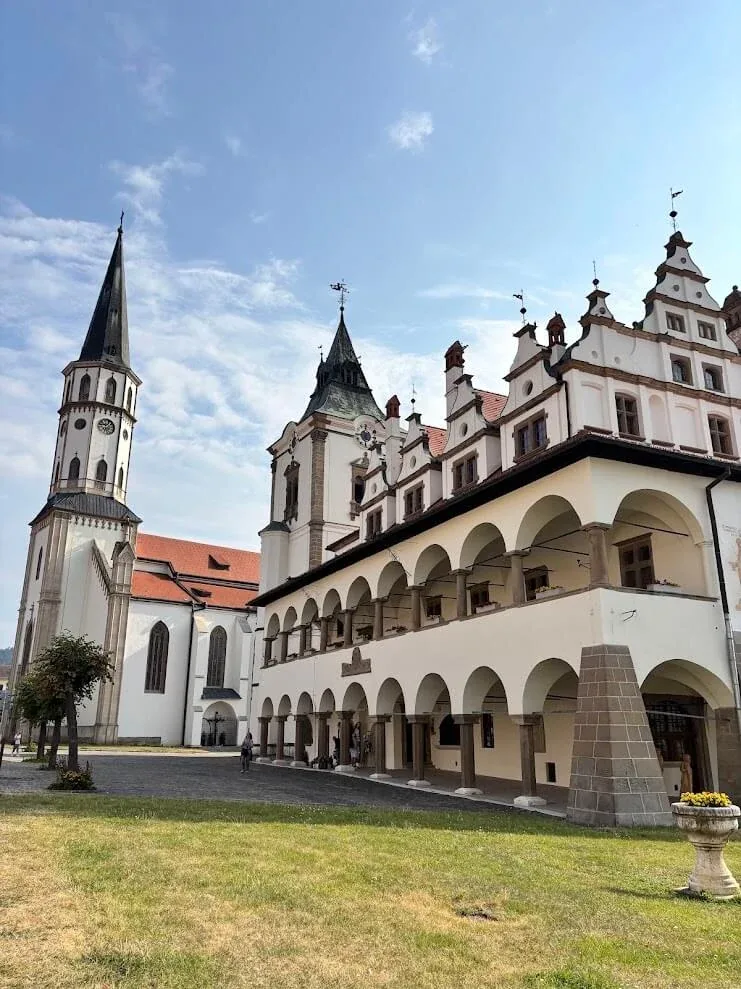 The arcaded Renaissance town hall of Levoča beside the tall spire of St James's Church on the main square.