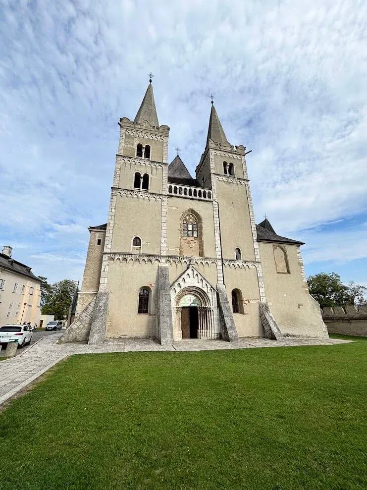 The twin Romanesque towers of St Martin's Cathedral at Spišská Kapitula, standing on the lawn inside its walled precinct.