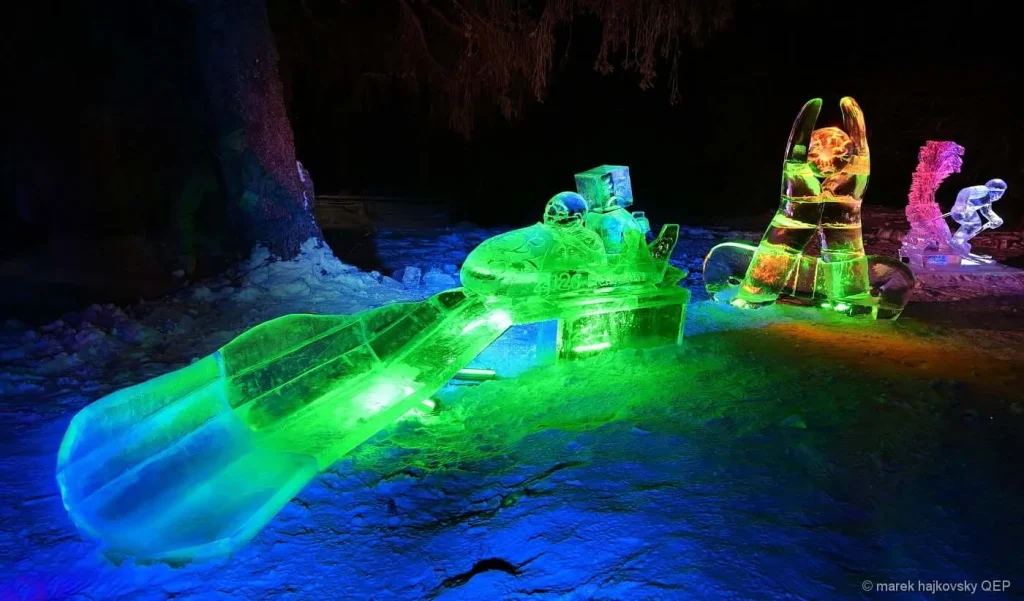 Illuminated ice sculptures inside the Tatra Ice Dome at Hrebienok in the High Tatras, lit in green and blue.