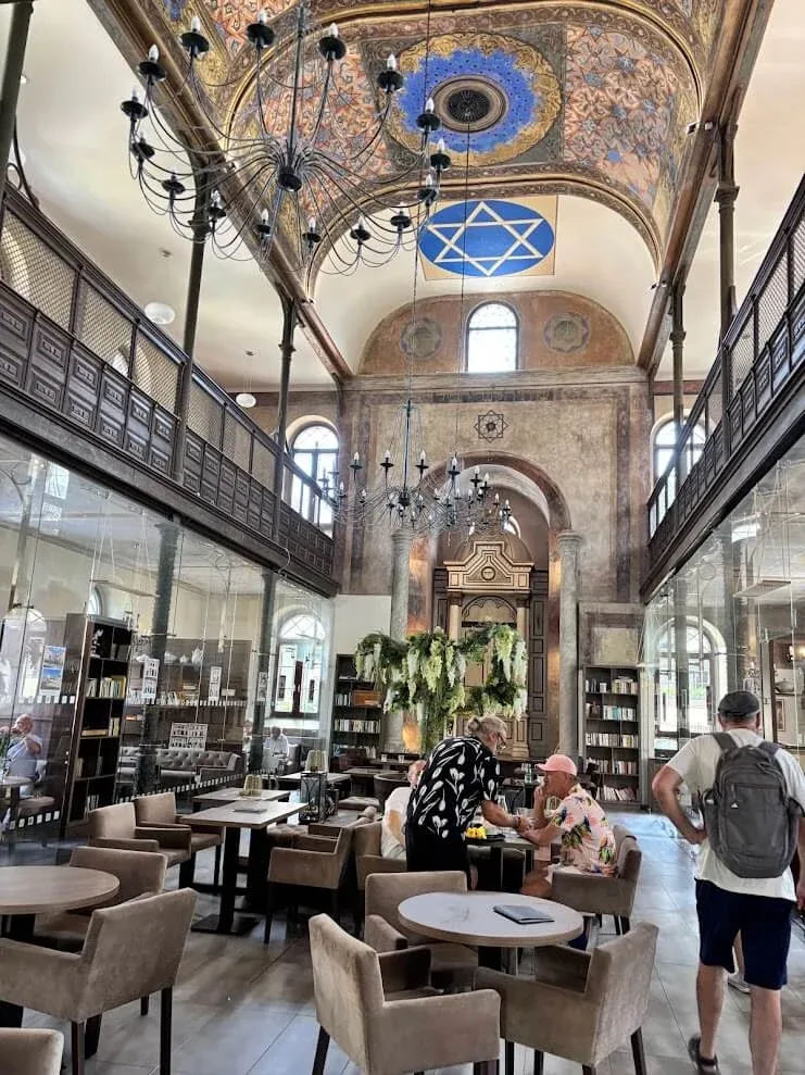 The former synagogue in Trnava, now a café and gallery, its painted vaults and Star of David above tables and bookshelves.