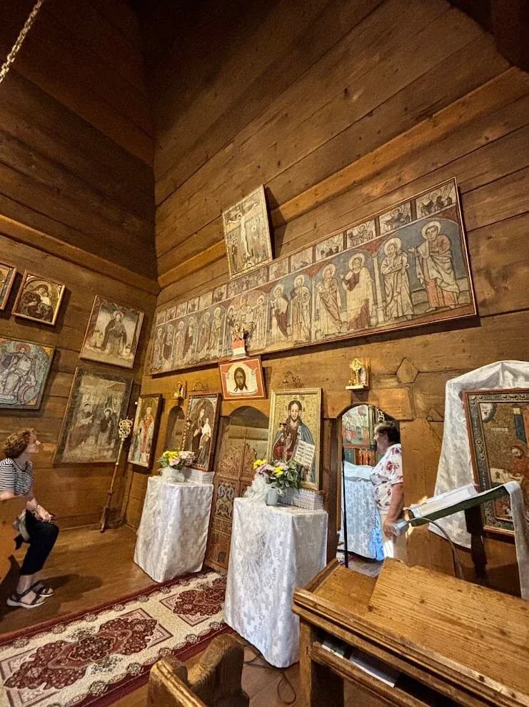 Icons lining the timber walls inside the Greek Catholic Church of St Luke at Tročany.