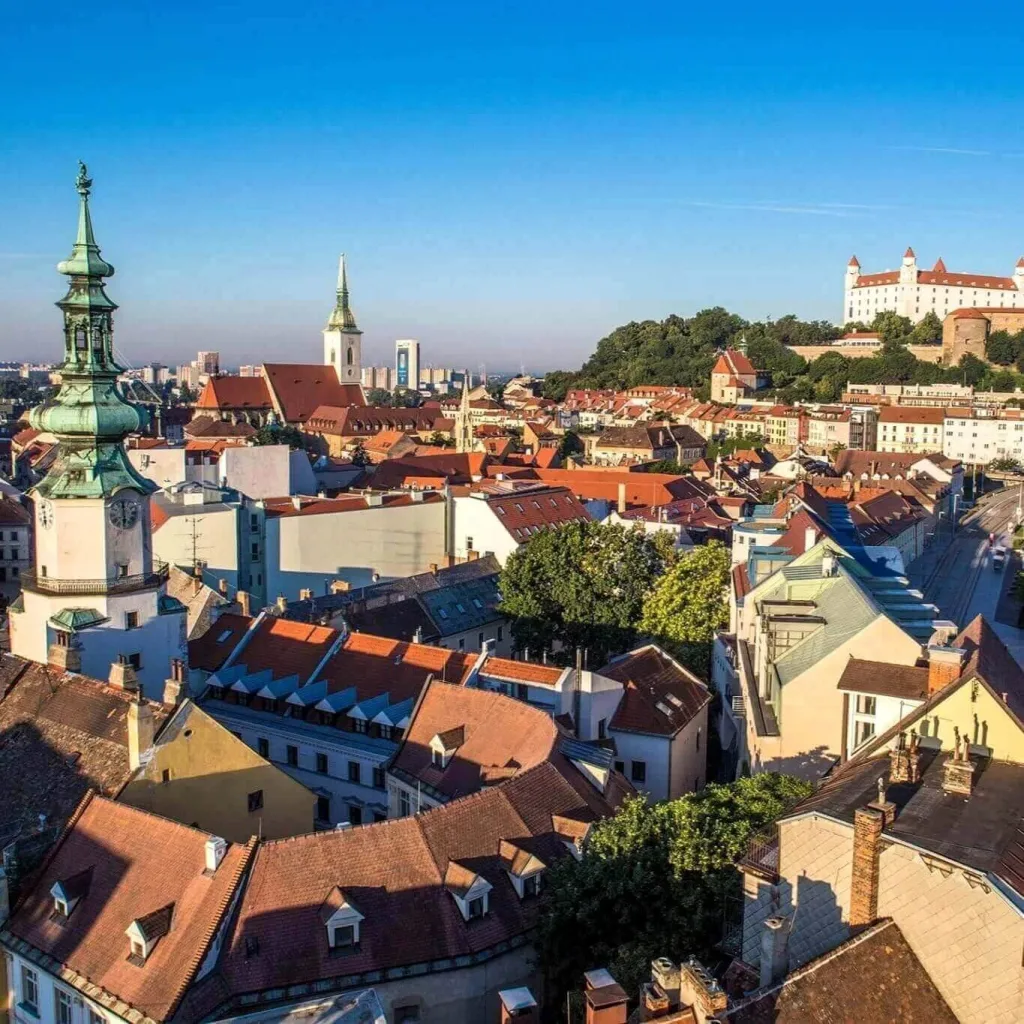 Bratislava’s Old Town from above: red roofs, the green tower of St Michael’s Gate, the spire of St Martin’s Cathedral and Bratislava Castle on the hill behind.