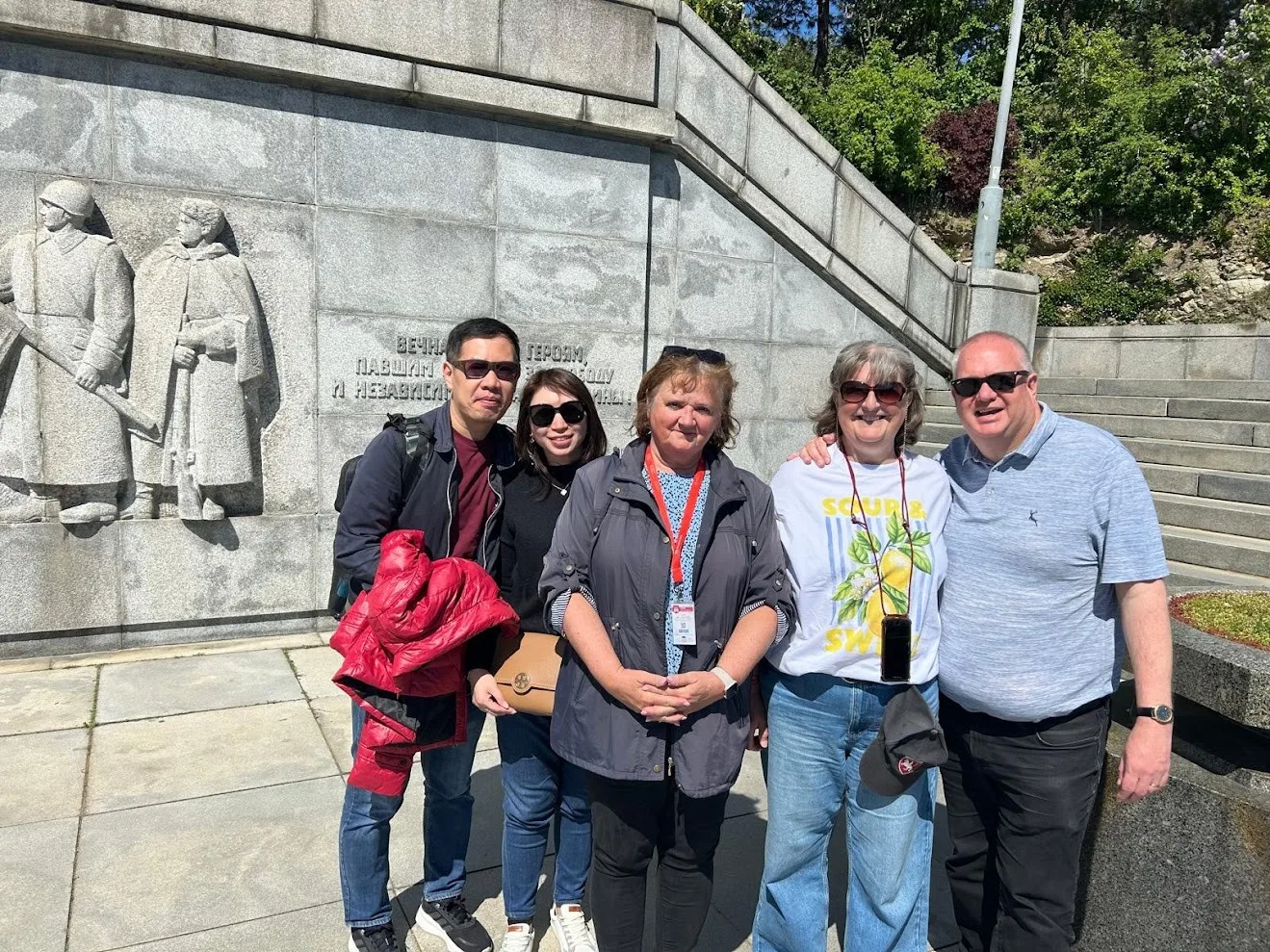 A small private group with their guide at the Slavín memorial above Bratislava, in front of the granite relief of soldiers and its Russian dedication to the fallen.