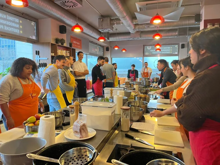 Delegates gathered around the demonstration counter during a team cooking class at the Chefparade cooking school in Bratislava.