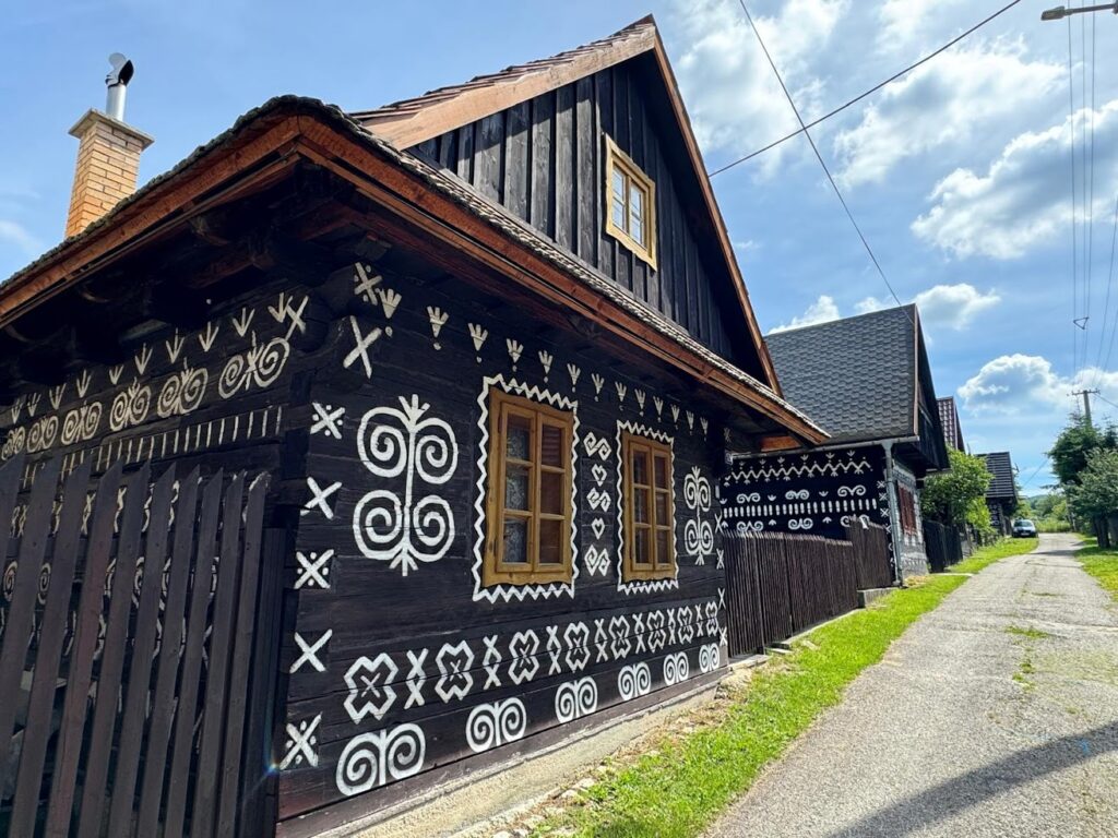 Cicmany traditional Slovak wooden village with wooden houses painted by white ornaments 