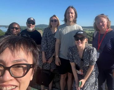 Small group of tourists enjoying a guided half-day trip to Devín Castle with views of the Danube River, Bratislava