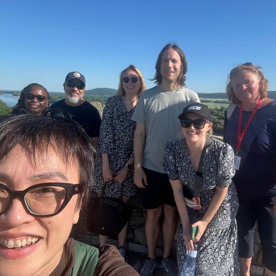 Small group of tourists enjoying a guided half-day trip to Devín Castle with views of the Danube River, Bratislava