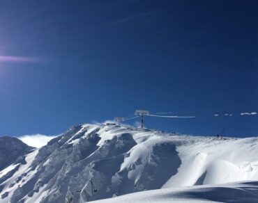 Wide sunlit piste and chairlifts on the Chopok slopes at Jasná ski resort in the Low Tatras, Slovakia