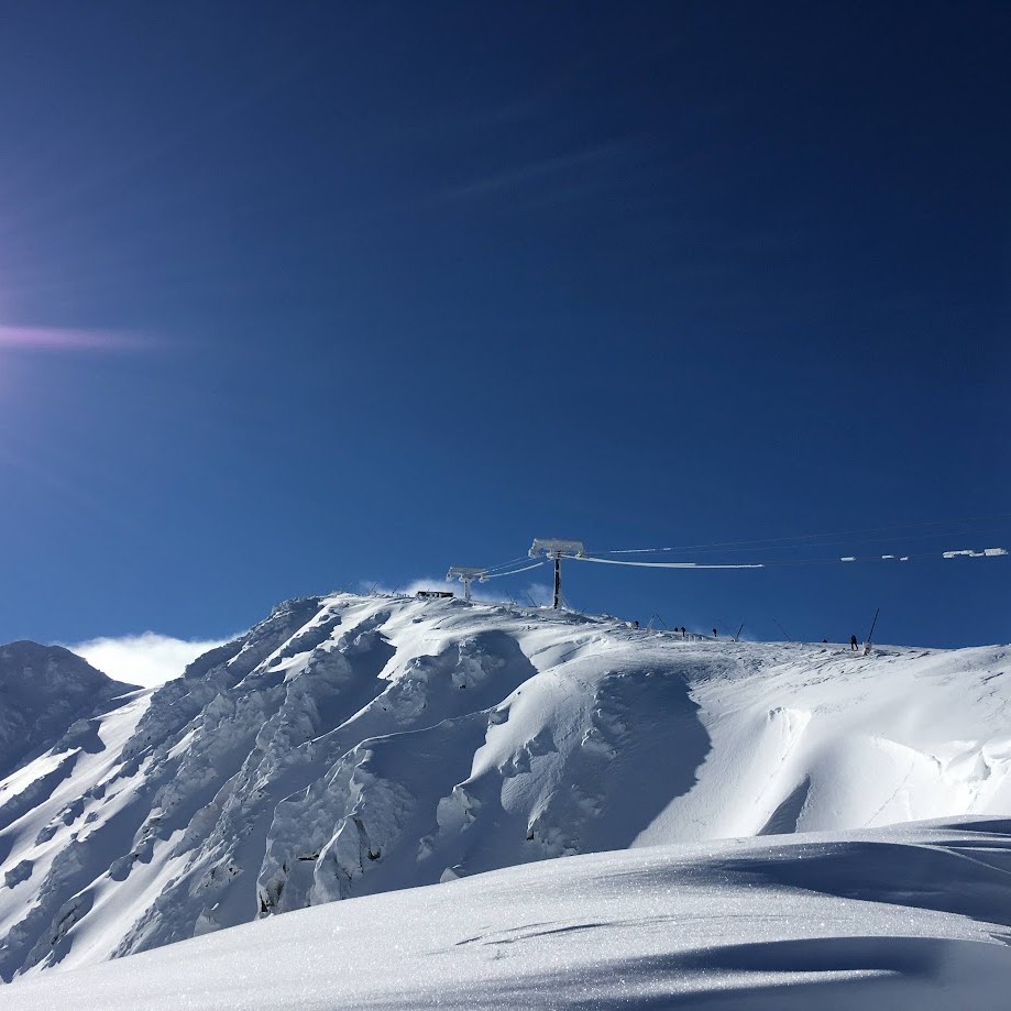 Wide sunlit piste and chairlifts on the Chopok slopes at Jasná ski resort in the Low Tatras, Slovakia